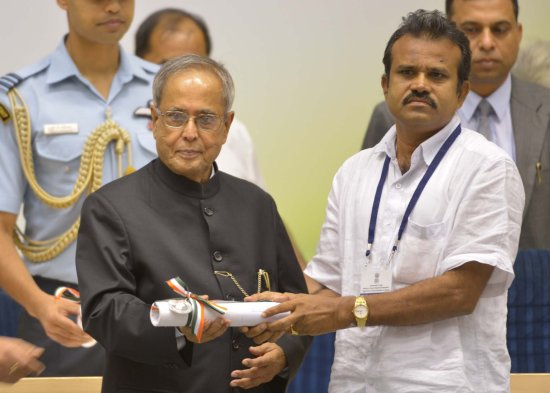 The President of India, Shri Pranab Mukherjee while presenting a National Award for the year 2012 on the occasion of Teachers’ Day at Vigyan Bhavan in New Delhi on September 5, 2013.