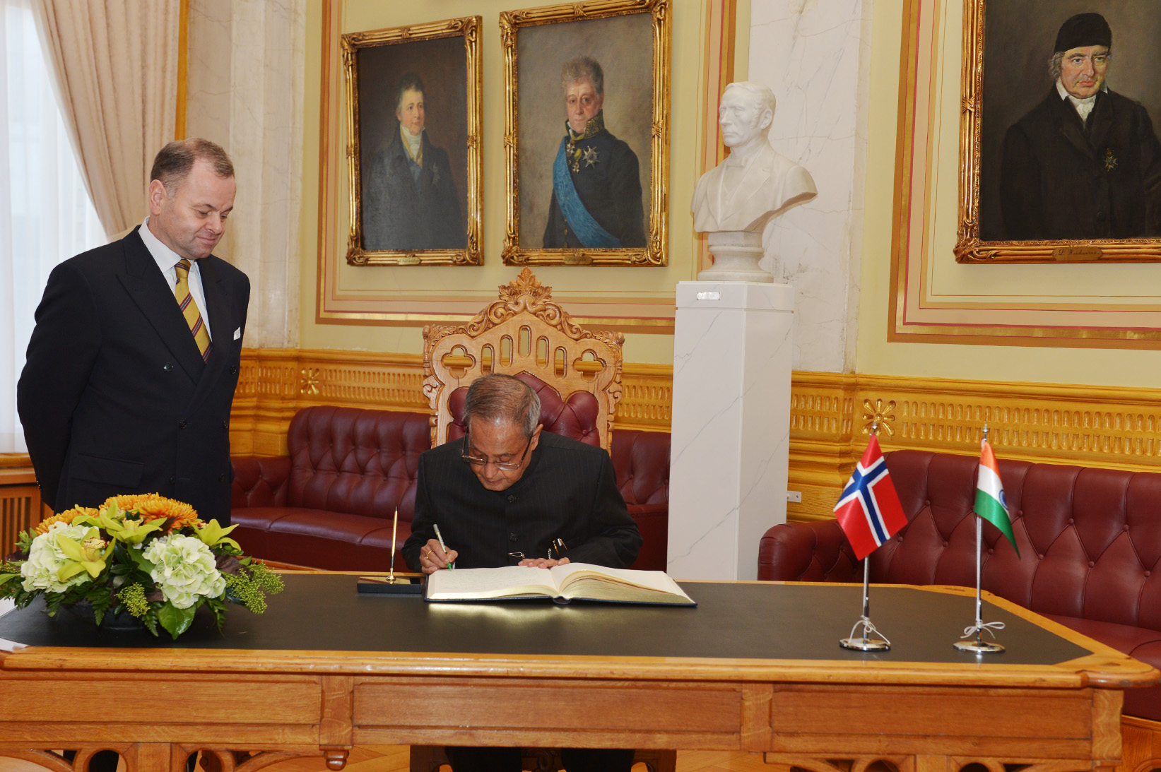 The President of India, Shri Pranab Mukherjee signing the visitor’s book during his visit to Storting (Parliament of Norway) at Oslo in Norway on October 13, 2014. Also seen is the President of Storting (Parliament of Norway), Mr. Olemic Thommessen. 