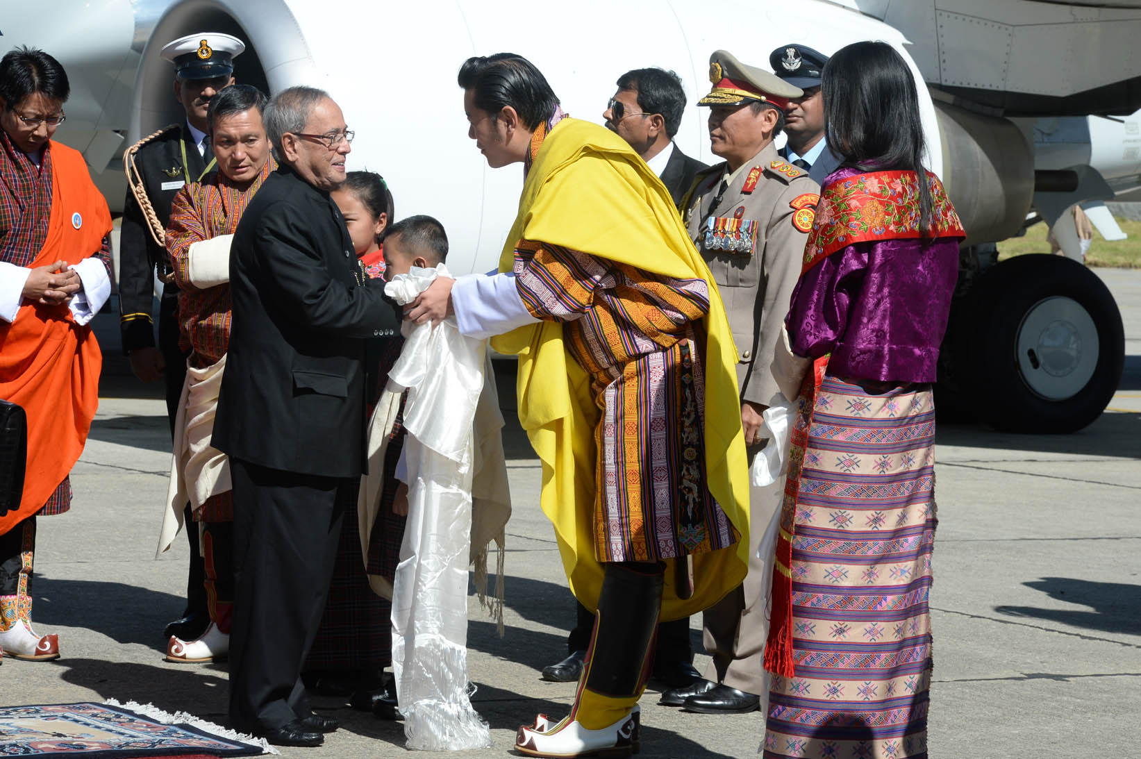 The President of India, Shri Pranab Mukherjee being received by King of Bhutan, His Majesty King Jigme Khesar Namgyel Wangchuck and the Bhutan Queen, Her Majesty Jetsun Pema Wangchuck on his arrival at Paro International Airport in Bhutan on November 7, 2 