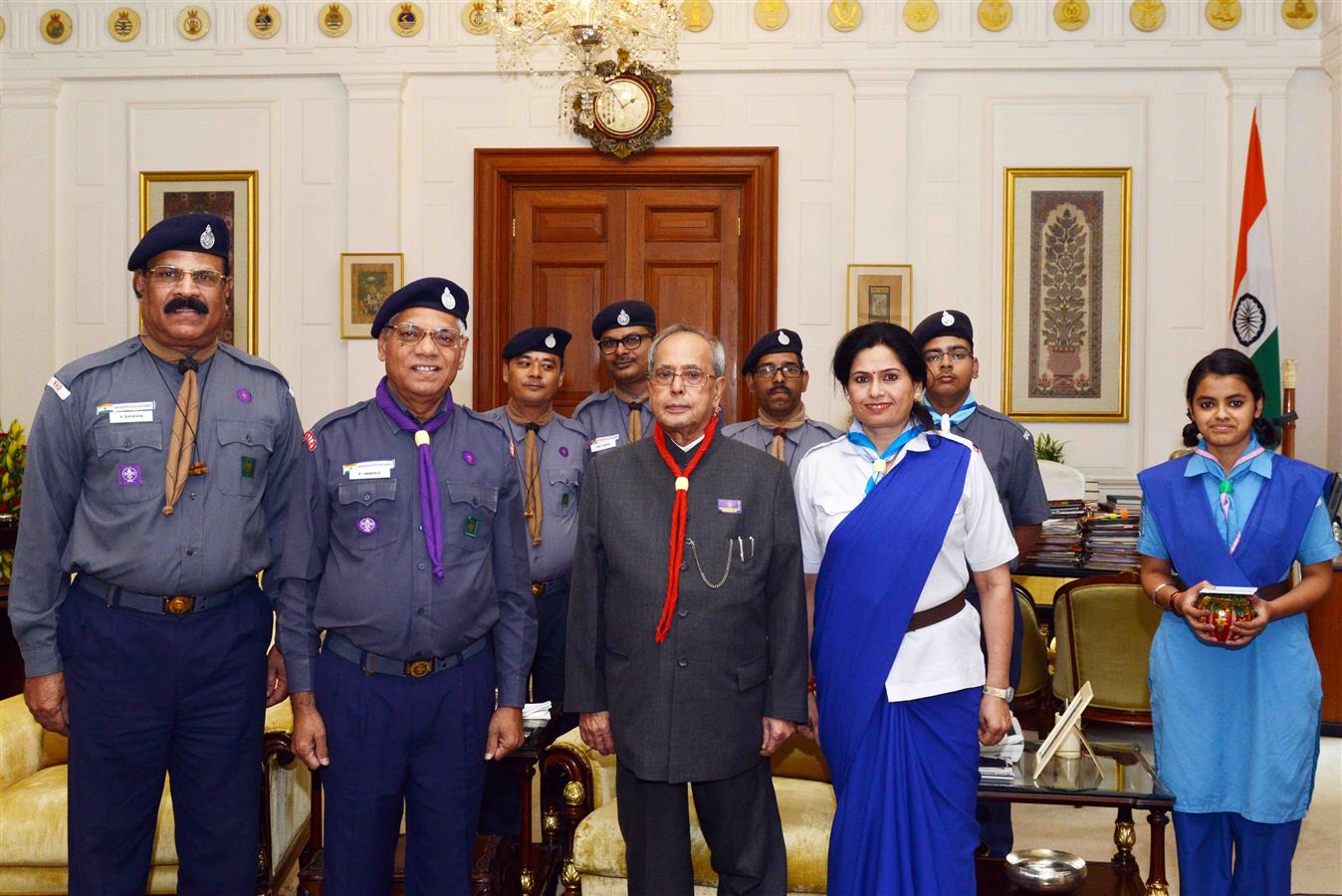 Shri BI Nagarale, Chief National Commissioner with other members from Bharat Scouts and Guides (National Headquarters) putting Flag on the President of India, Shri Pranab Mukherjee on the occasion of Bharat Scouts and Guides Foundation Day at Rashtrapati