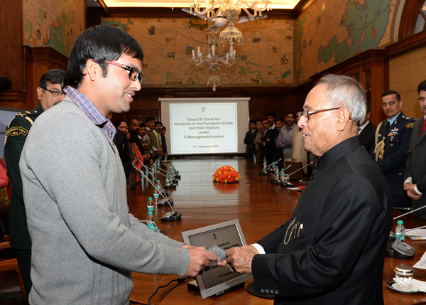 The President of India, Shri Pranab Mukherjee while presenting a Smart ID Card for Residents from President’s Estate and their Visitors at Rashtrapati Bhavan in New Delhi on December 11, 2013.